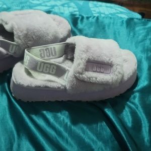Purple fluffy Uggs slips ons with back elastic strap.